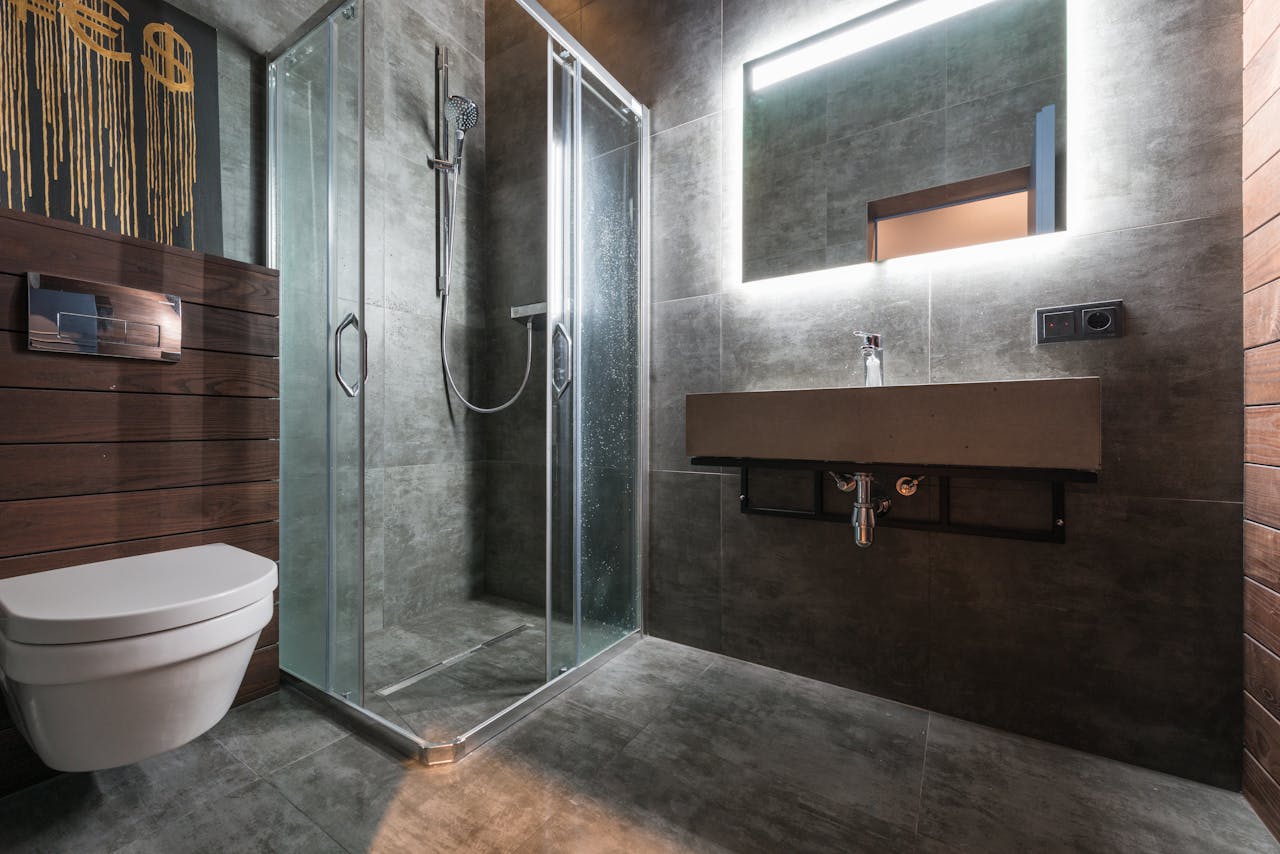 Sleek modern bathroom featuring a glass shower and elegant fixtures.